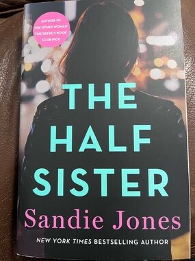 The Half Sister by Sandie Jones - Black Cover with Teal & Pink Text